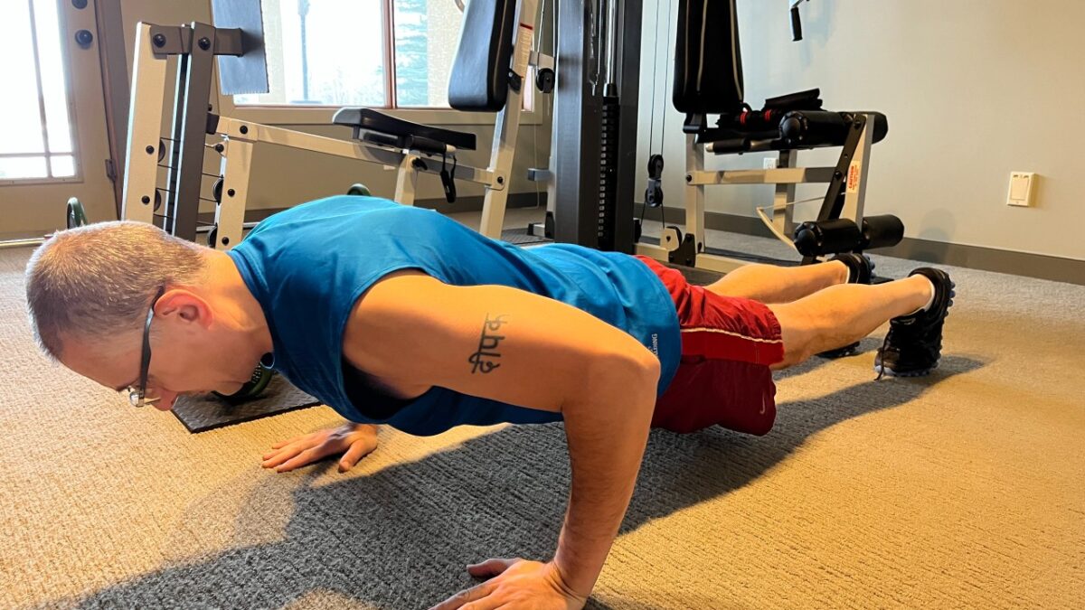 Man performing push-up in a gym